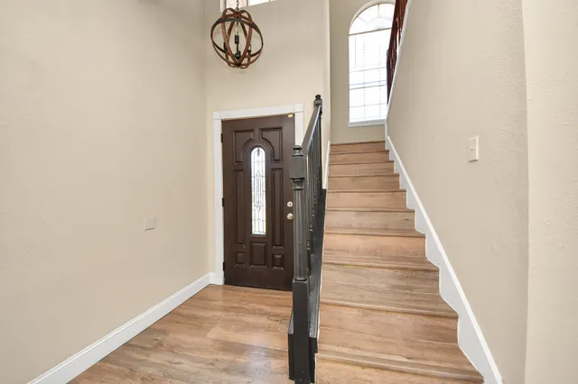 a view of entryway and hall with wooden floor