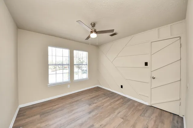 a view of a livingroom with a ceiling fan and window