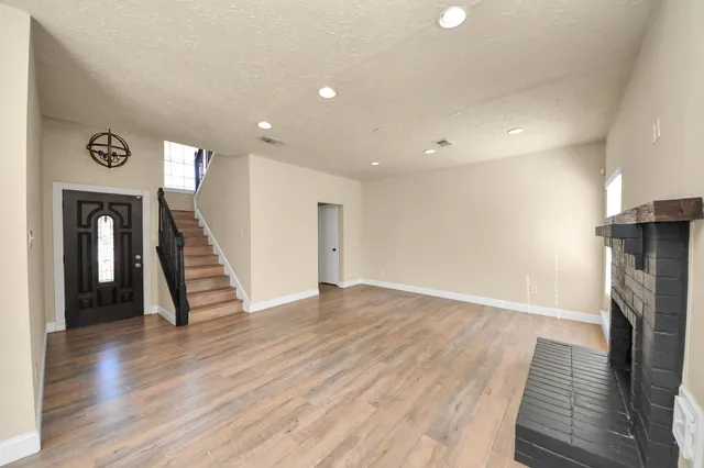 wooden floor in an empty room with a fireplace