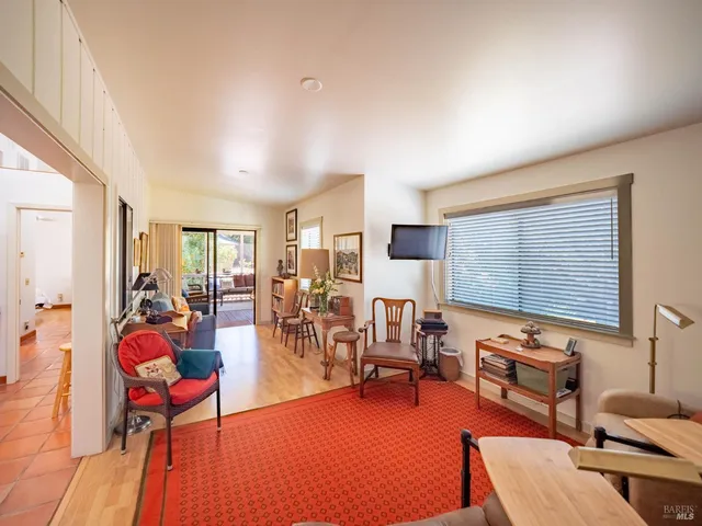 a living room with furniture a rug and a large window