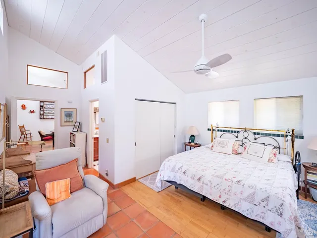 a bedroom with a bed and ceiling fan