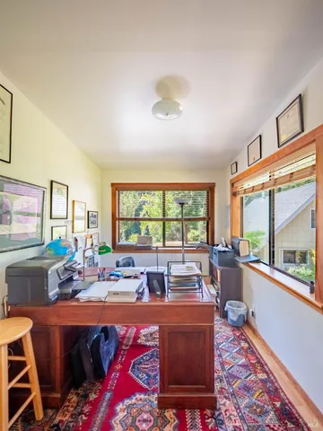 a living room with furniture a rug and a large window