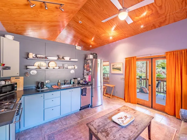 a open kitchen with stainless steel appliances granite countertop a sink stove and refrigerator