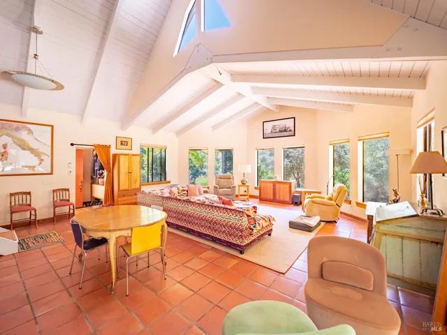 a living room with fireplace furniture and a large window