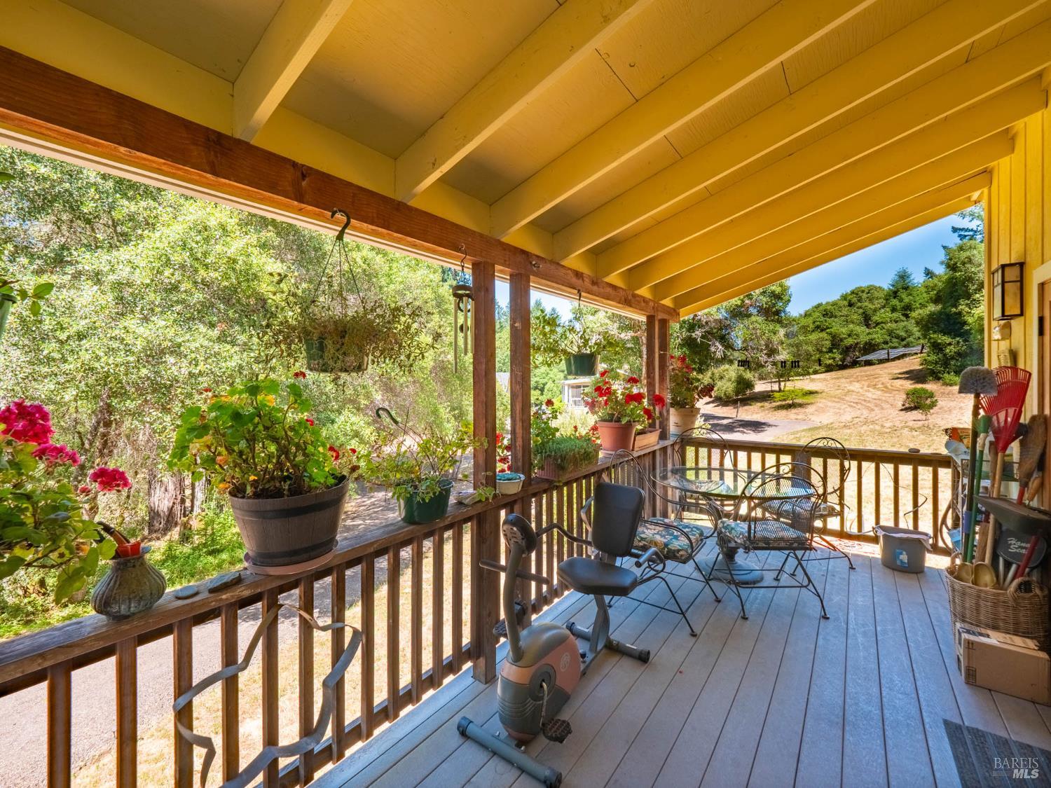 2151 Highway 128 Philo, CA 95466 - Photo 43 of 55 Perched on stilts with a welcoming front staircase, the cottage has a storybook charm. The generous covered front porch overlooks serene woodland surroundings, making it ideal for morning coffee, evening wine, or simply watching the birds flit through the trees.