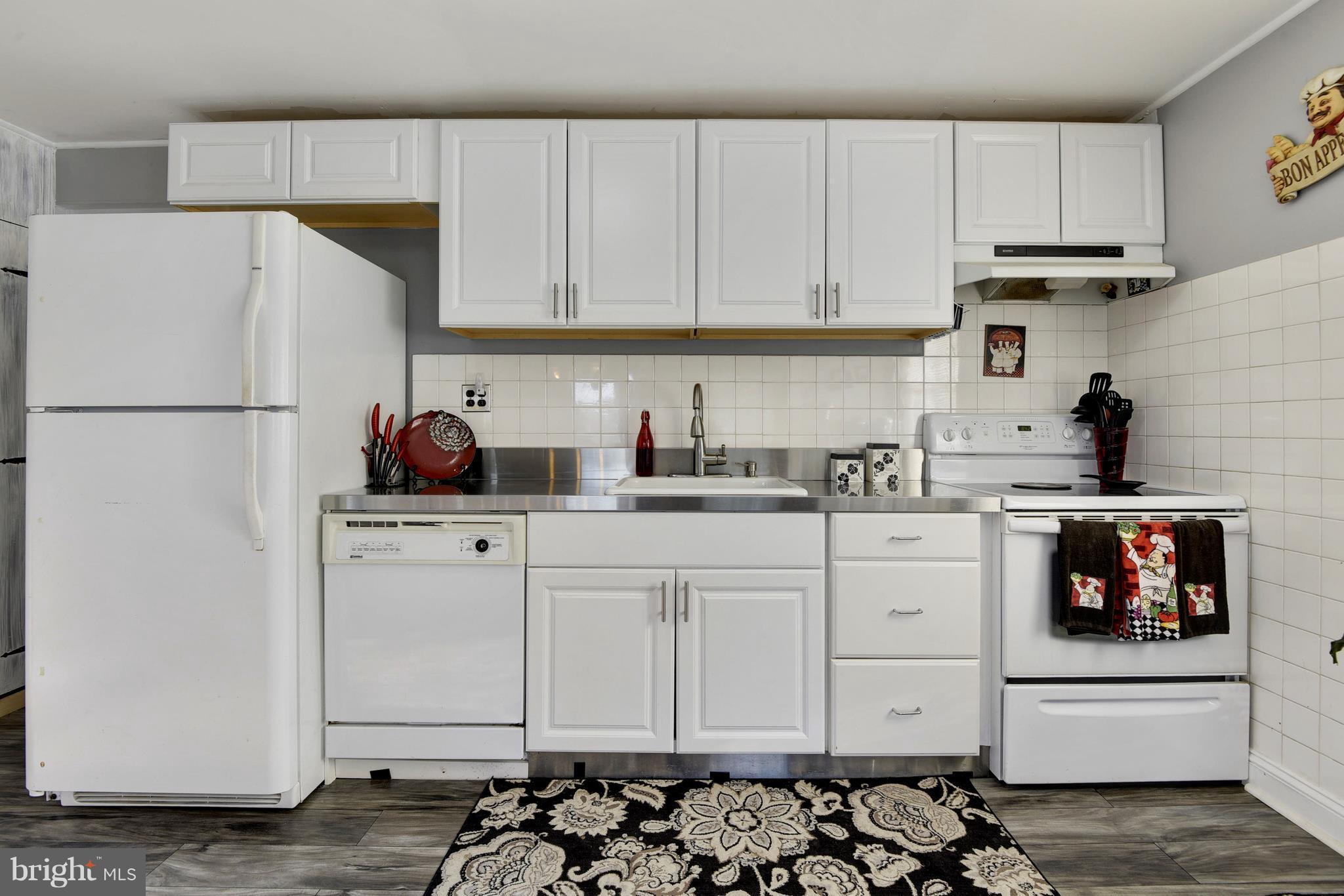 5734 Swamp Circle Road Deale, MD 20751 - Photo 11 of 30 a kitchen with a sink and white cabinets