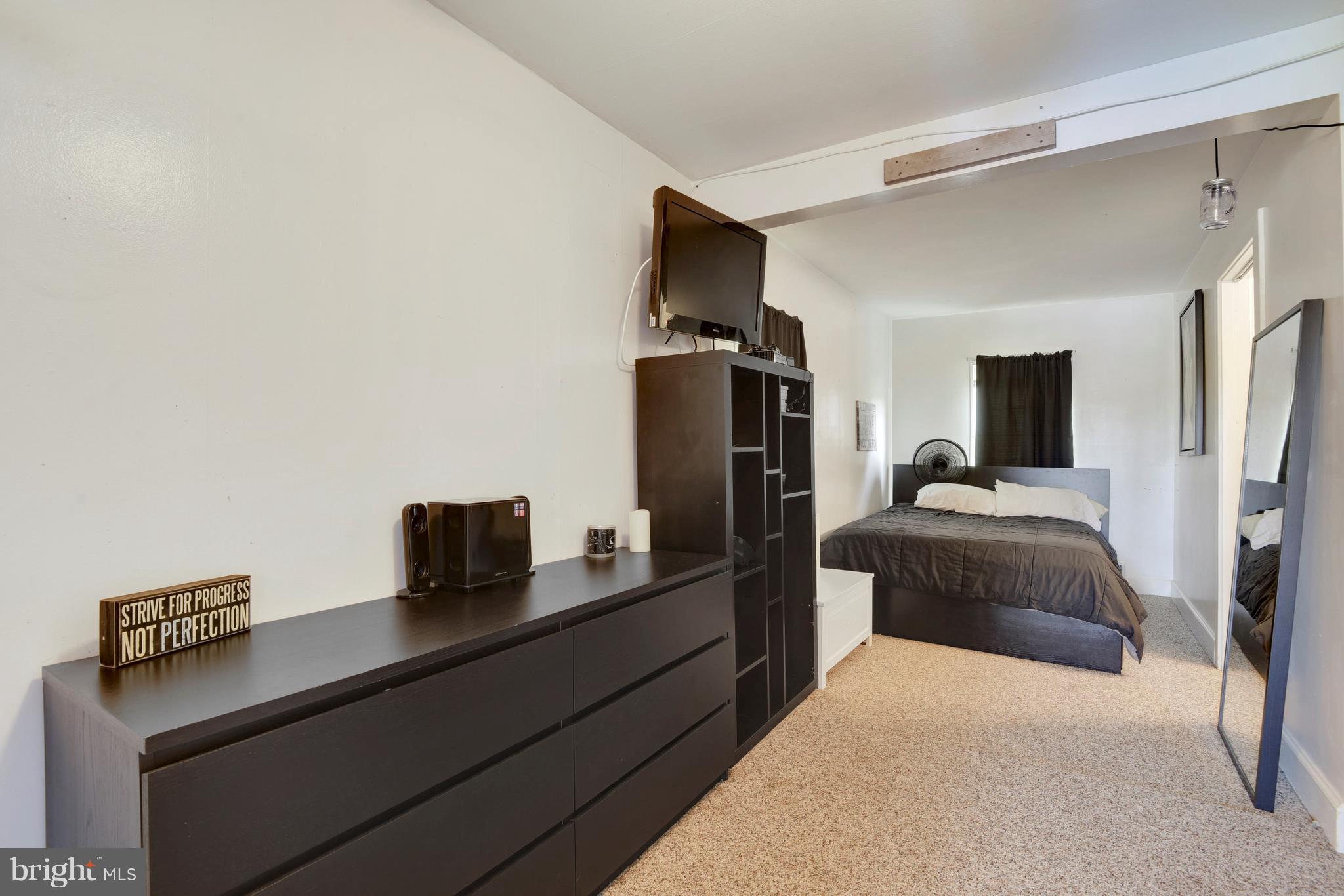 5734 Swamp Circle Road Deale, MD 20751 - Photo 18 of 30 a bedroom with a bed and a flat screen tv