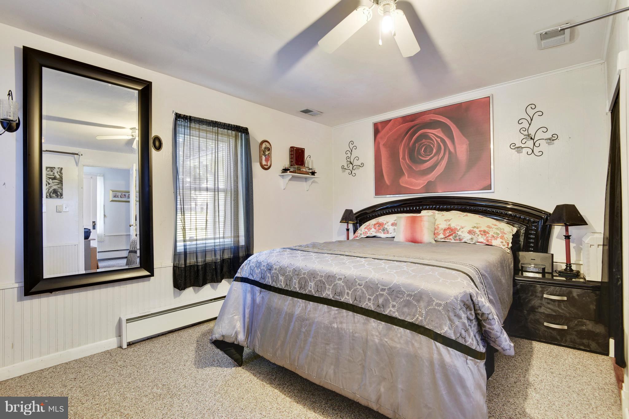 5734 Swamp Circle Road Deale, MD 20751 - Photo 22 of 30 a bedroom with a bed and a large mirror
