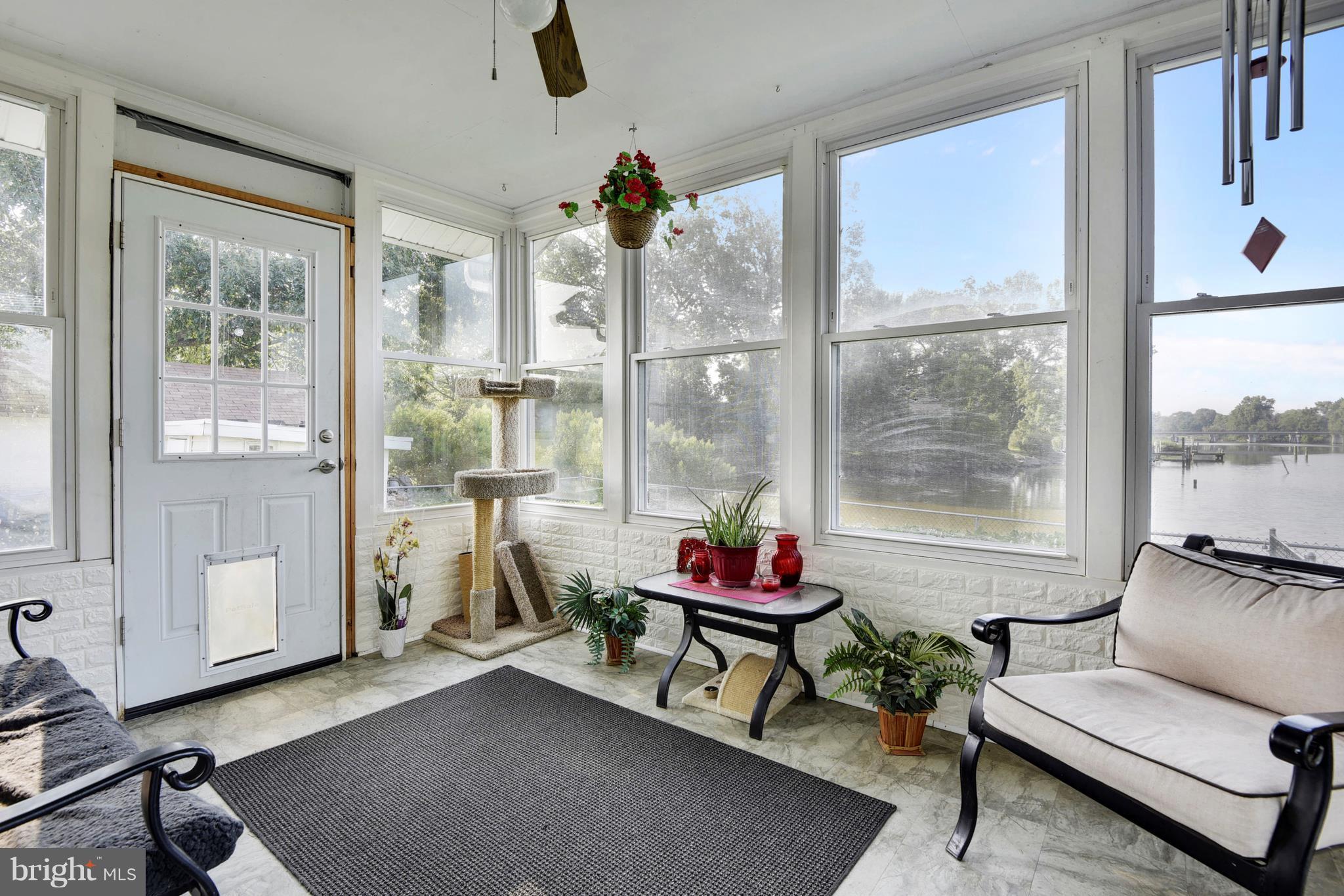 5734 Swamp Circle Road Deale, MD 20751 - Photo 28 of 30 a living room with furniture and a floor to ceiling window