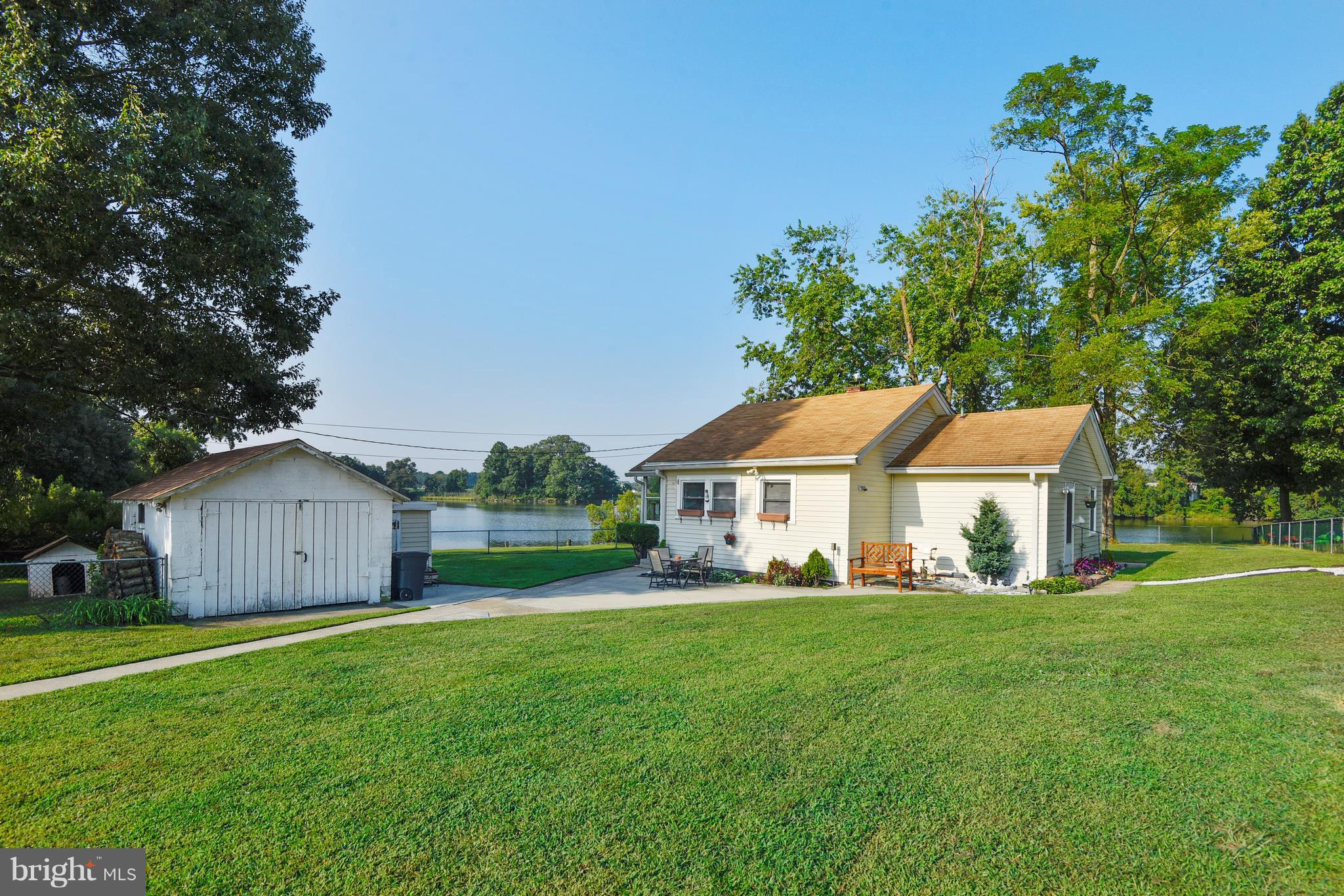 5734 Swamp Circle Road Deale, MD 20751 - Photo 4 of 30 a view of a house with a big yard potted plants and large tree