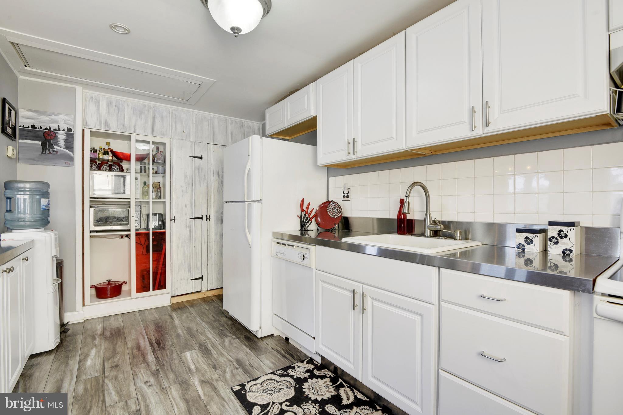 5734 Swamp Circle Road Deale, MD 20751 - Photo 10 of 30 a kitchen with stainless steel appliances a sink and cabinets