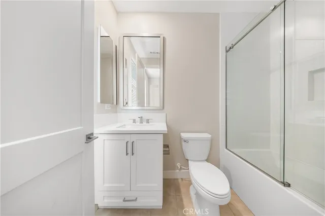 a white toilet sitting next to a bathroom sink