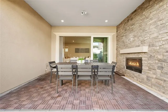 a dining room with a wooden floor and a fireplace