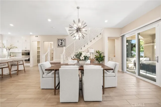 a living room with fireplace furniture and a chandelier