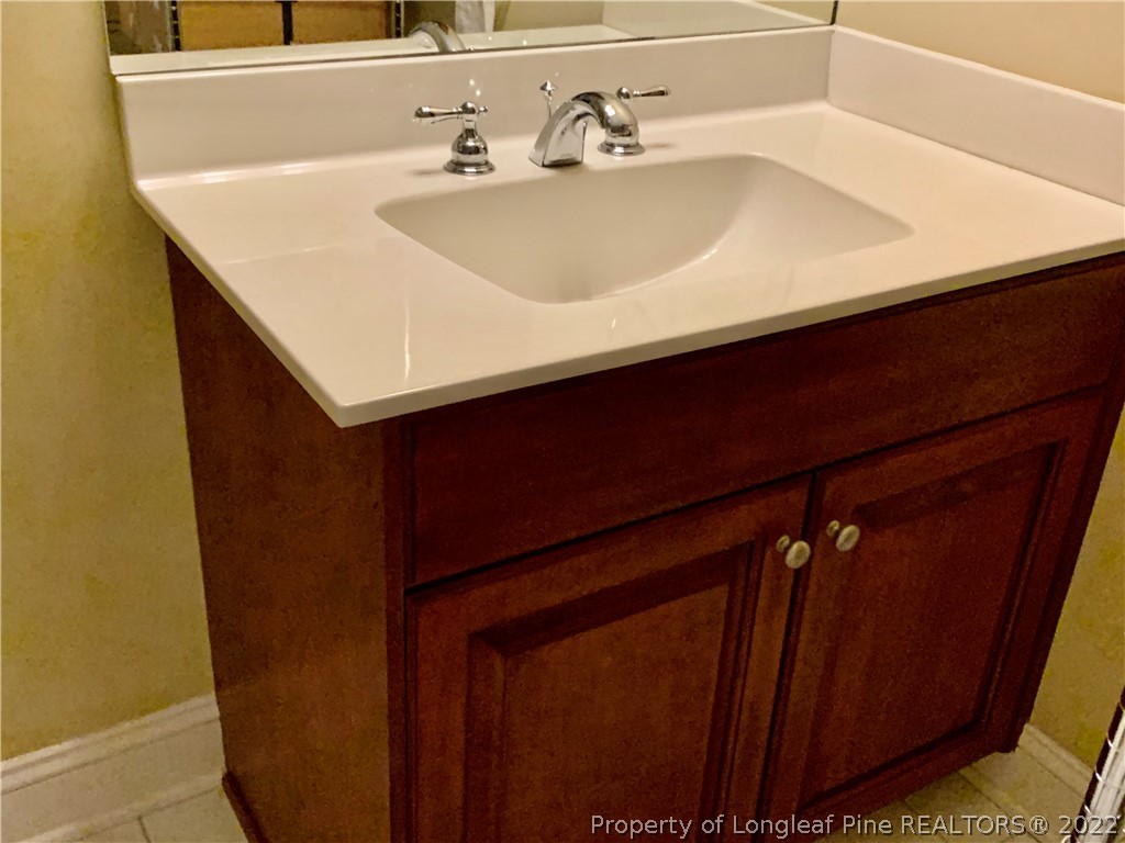 2651 Lockwood Road Fayetteville, NC 28303 - Photo 13 of 18 a bathroom with a sink and a mirror