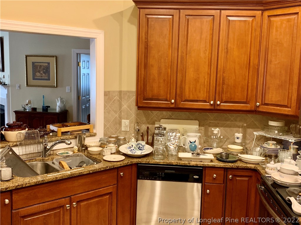 2651 Lockwood Road Fayetteville, NC 28303 - Photo 7 of 18 a kitchen with a sink cabinets and wooden floor