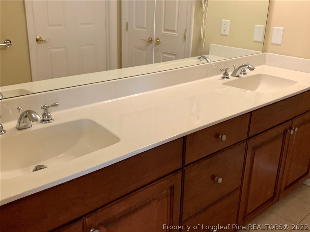 2651 Lockwood Road Fayetteville, NC 28303 - Photo 10 of 18 a bathroom with a sink and a mirror