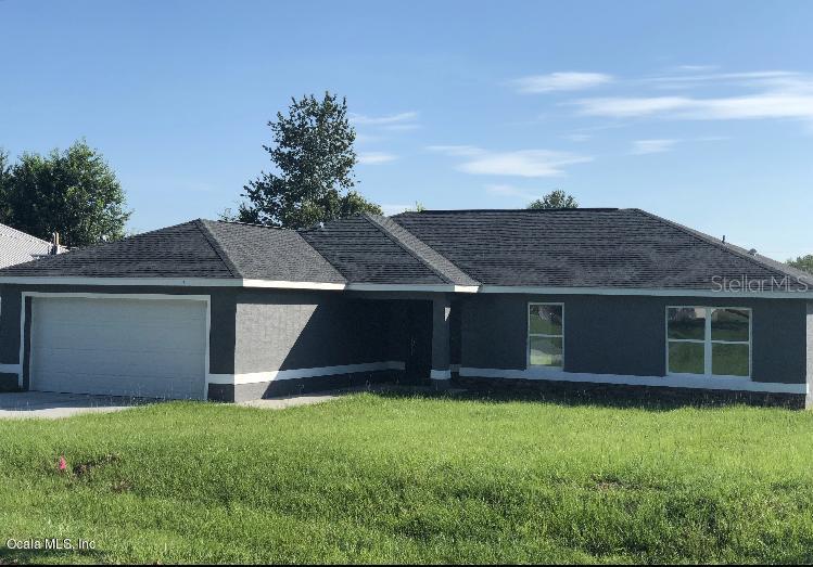 6910 Hemlock Road Ocala, FL 34472 - Photo 1 of 1 a view of front of house with a yard