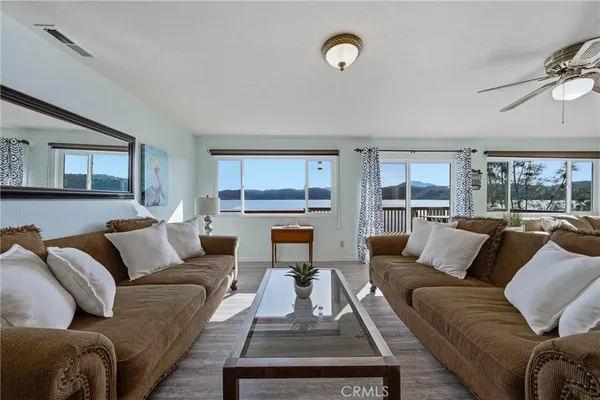 a living room with furniture wooden floor and a large window