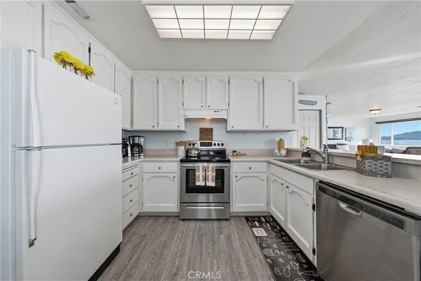 a kitchen with a white cabinets and white appliances