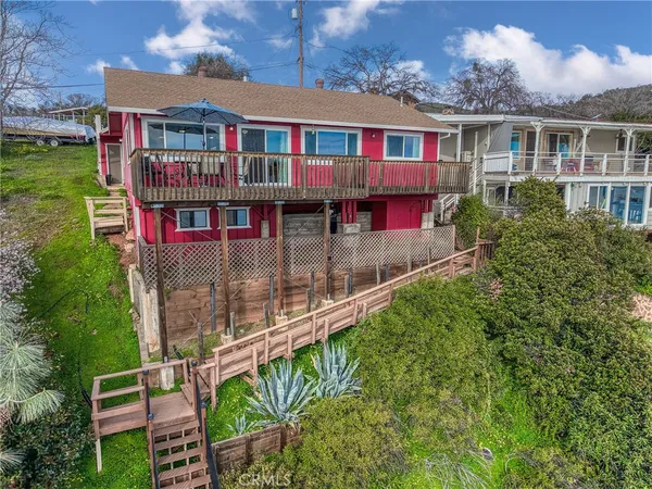 a front view of a house with balcony and garden