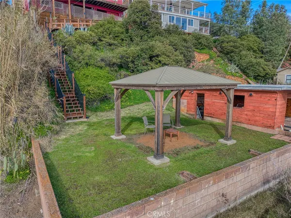 a view of a patio with a table and chairs under an umbrella