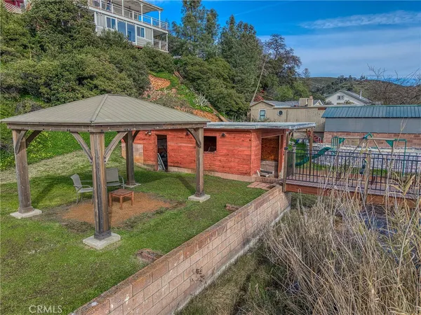 a view of a chairs and table on the wooden deck