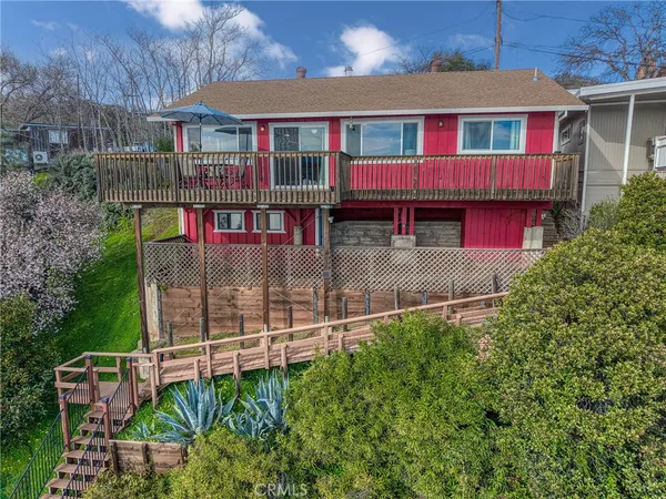 a view of a lake with table and chairs