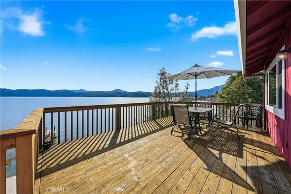 a view of a patio with a table and chairs under an umbrella with wooden floor