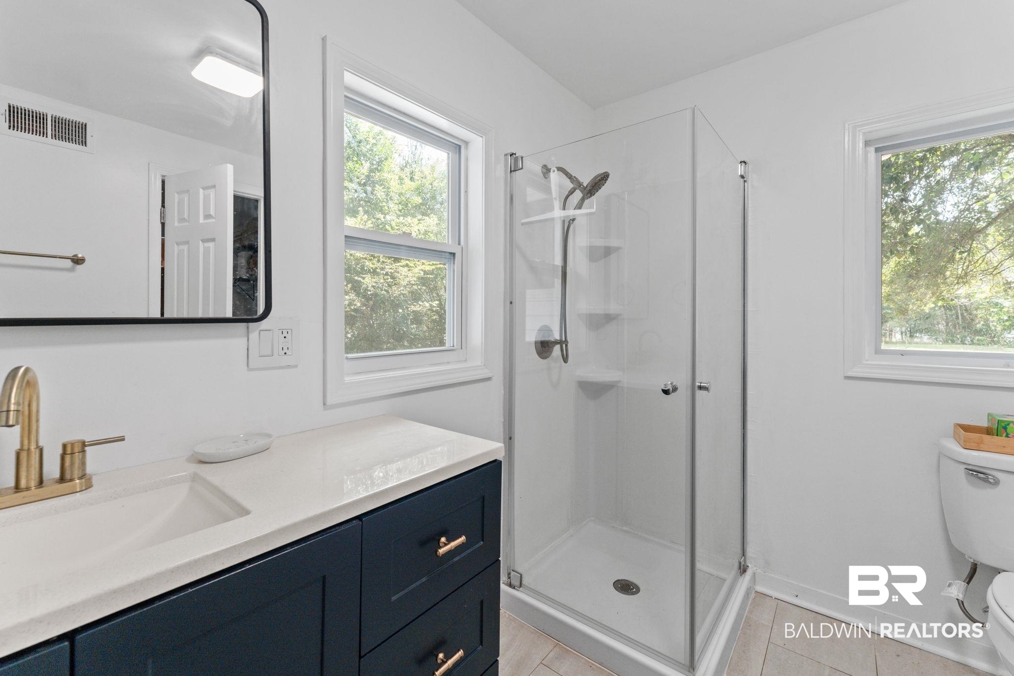 10785 Gregg Road Semmes, AL 36575 - Photo 15 of 35 Bathroom with a shower stall, vanity, and light tile patterned floors