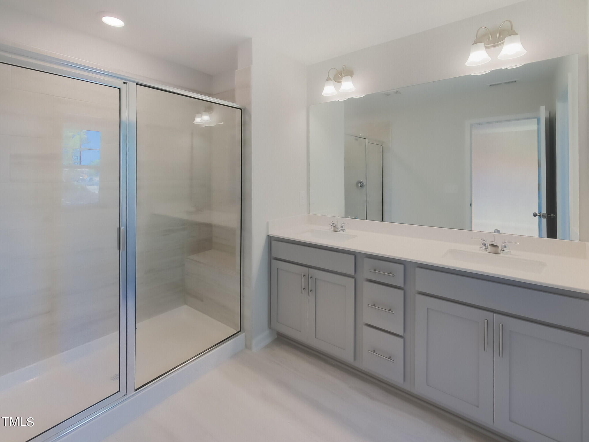 224 Deercroft Drive Apex, NC 27539 - Photo 15 of 39 a bathroom with double sink and a mirror