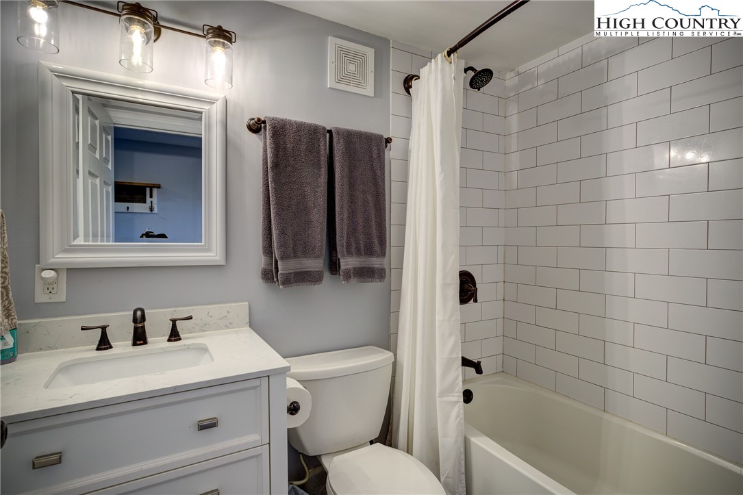 303 Sugar Top Drive, Unit 2407 Sugar Mountain, NC 28604 - Photo 14 of 36 a bathroom with a sink toilet and shower