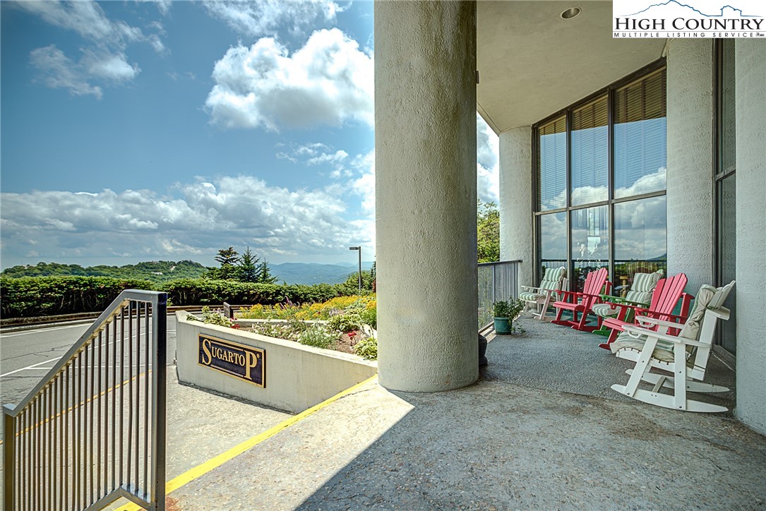 303 Sugar Top Drive, Unit 2407 Sugar Mountain, NC 28604 - Photo 26 of 36 a view of a terrace with furniture and a floor to ceiling window