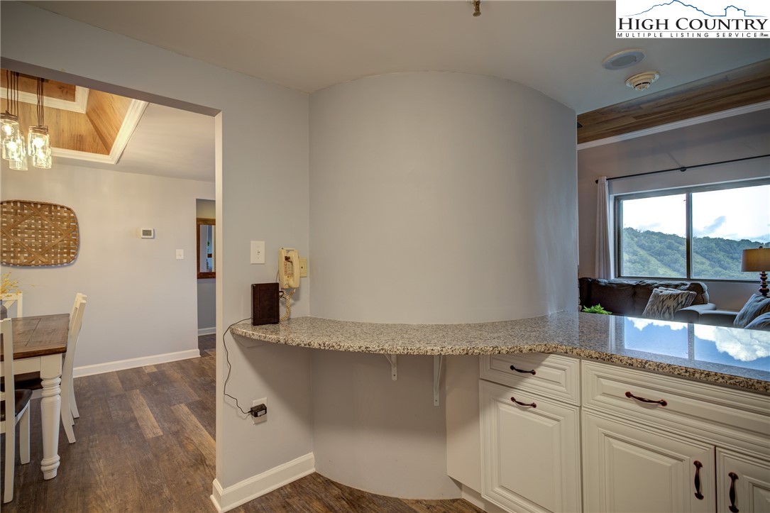 303 Sugar Top Drive, Unit 2407 Sugar Mountain, NC 28604 - Photo 5 of 36 a living room with granite countertop furniture and a fireplace