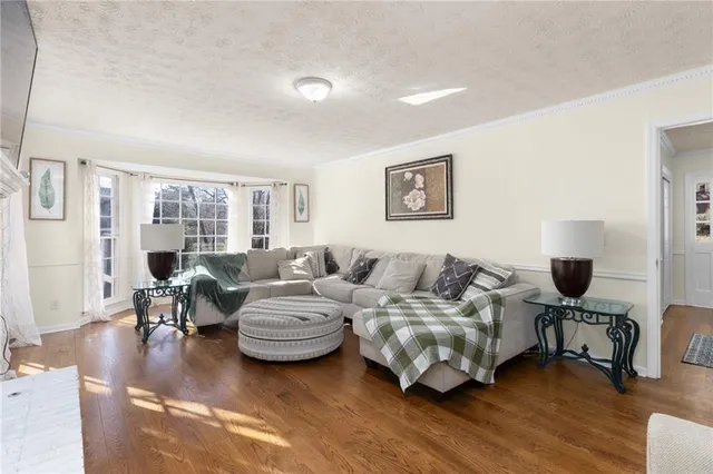a view of a dining room with furniture wooden floor and chandelier