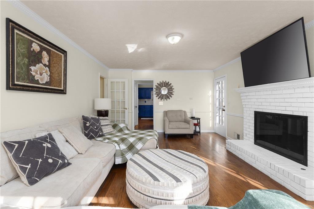 705 Springview Court Roswell, GA 30076 - Photo 12 of 79 a living room with furniture a flat screen tv and a fireplace