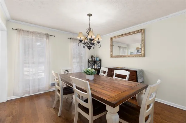 a kitchen with stainless steel appliances granite countertop a kitchen island a cabinets a sink and a refrigerator