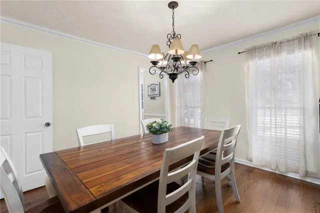 a kitchen with stainless steel appliances granite countertop a refrigerator stove and wooden floor