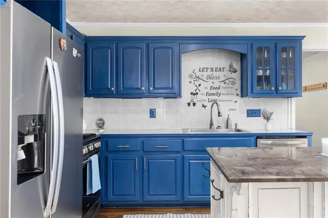 a kitchen with stainless steel appliances granite countertop a sink stove and cabinets