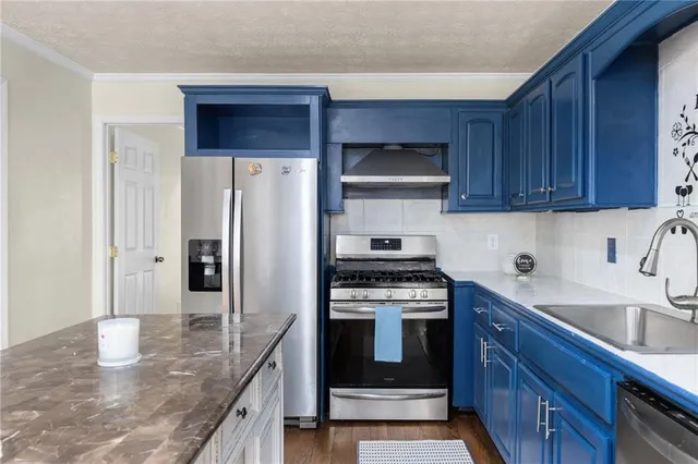 a kitchen with a sink and wooden cabinets