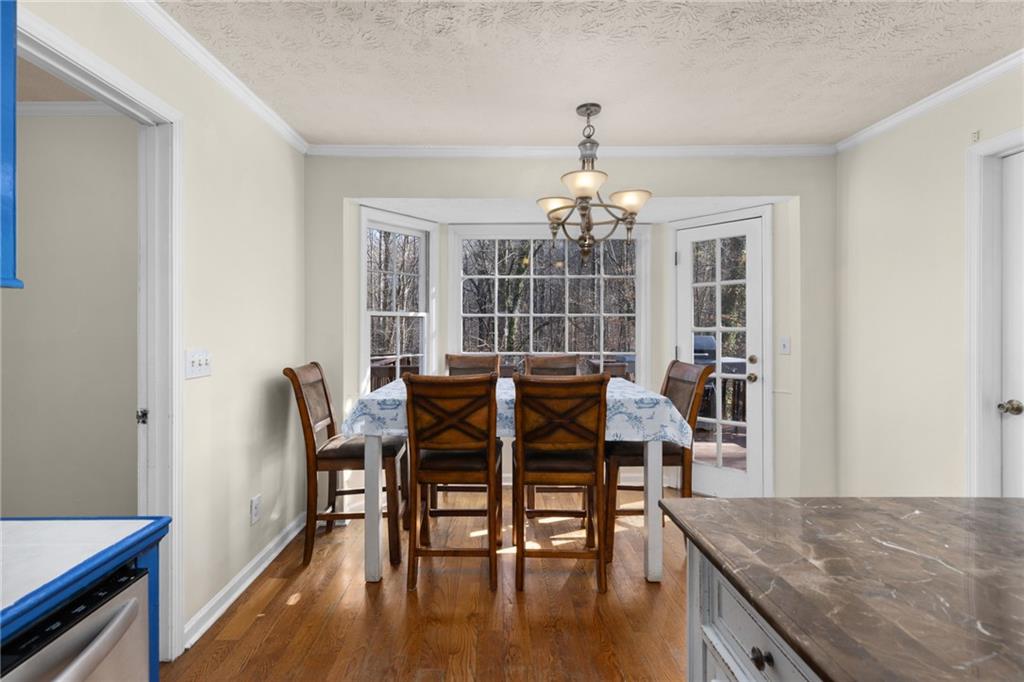 705 Springview Court Roswell, GA 30076 - Photo 24 of 79 a view of a dining room with furniture window and wooden floor