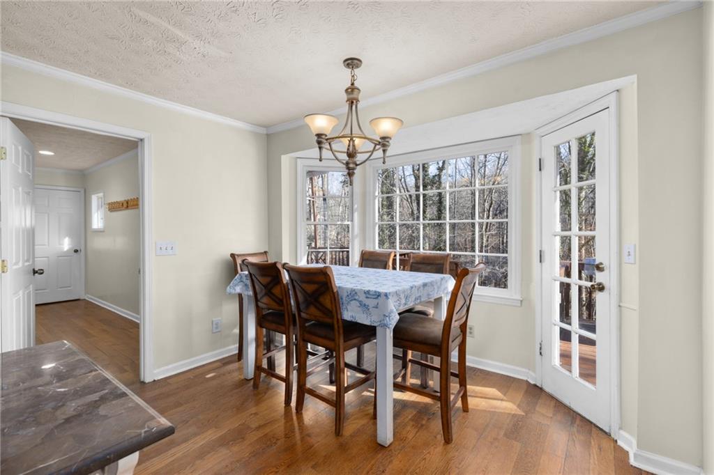 705 Springview Court Roswell, GA 30076 - Photo 25 of 79 a view of a dining room with furniture wooden floor and chandelier