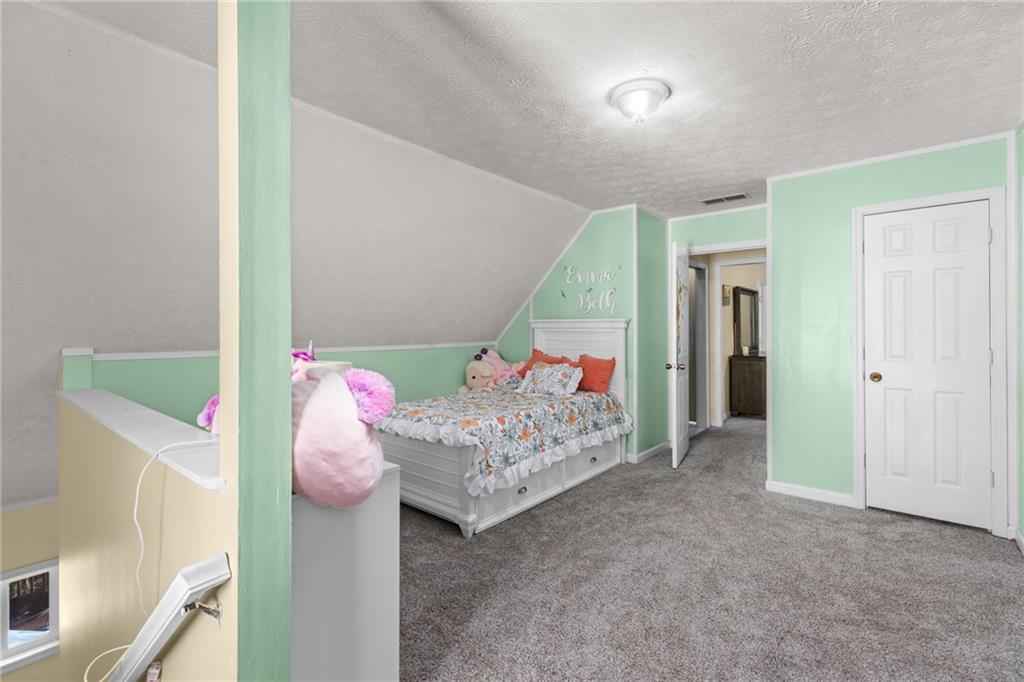 705 Springview Court Roswell, GA 30076 - Photo 33 of 79 a bedroom with furniture and a bed