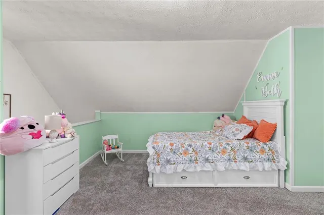 a view of a hallway with wooden floor and closet