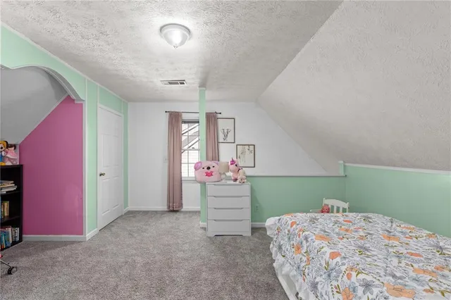 a bathroom with a sink a toilet and shower curtain