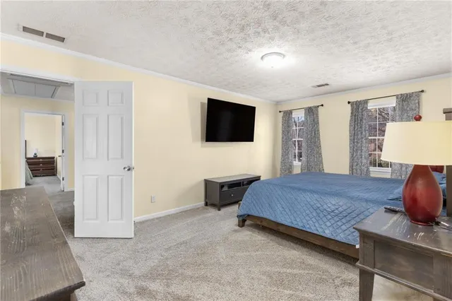 a bedroom with furniture and a flat screen tv