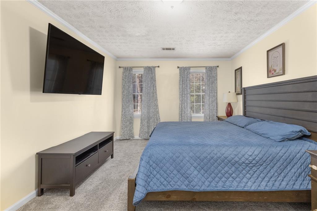 705 Springview Court Roswell, GA 30076 - Photo 39 of 79 a bedroom with a bed and a flat screen tv
