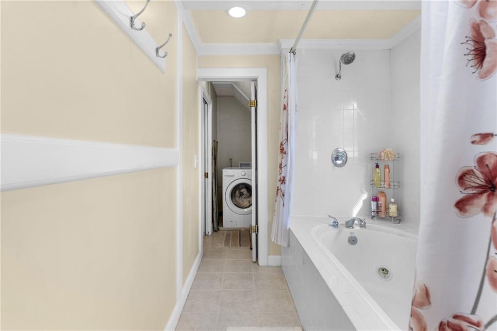 705 Springview Court Roswell, GA 30076 - Photo 42 of 79 a bathroom with a tub shower and sink