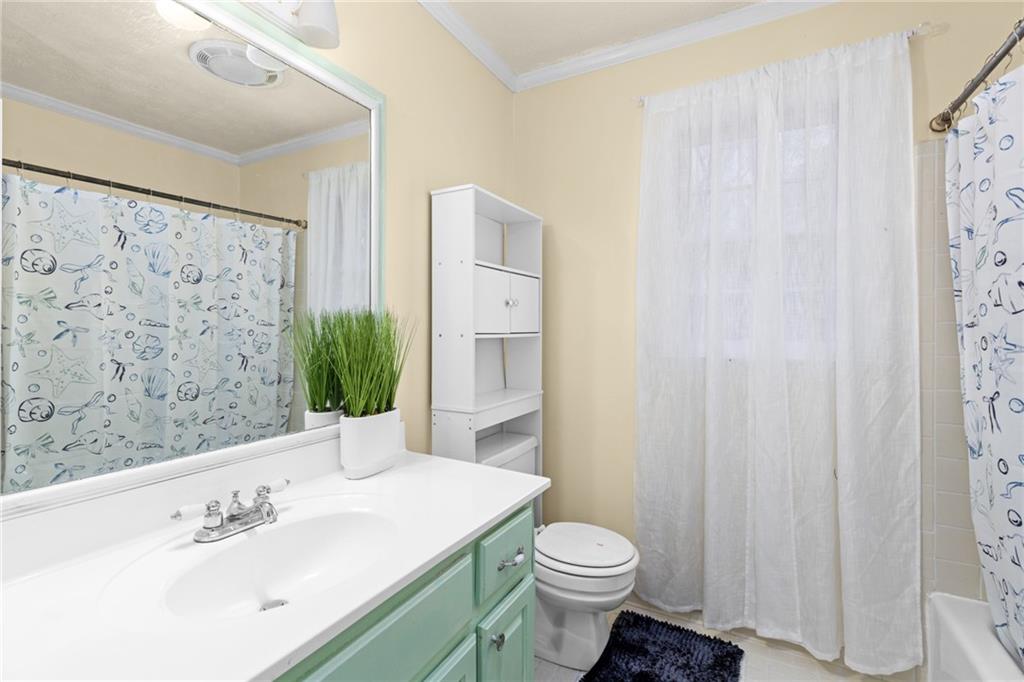 705 Springview Court Roswell, GA 30076 - Photo 47 of 79 a bathroom with a sink a toilet and shower curtain