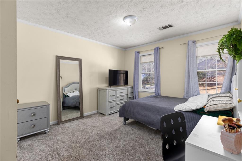 705 Springview Court Roswell, GA 30076 - Photo 51 of 79 a bedroom with furniture and a flat screen tv